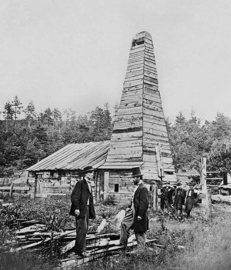 Edwin L. Drake standing in front of the first U.S. commercial oil well at Titusville, Pennsylvania, 1859