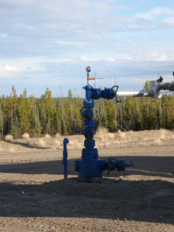 A wellhead Christmas tree assembly in northern British Columbia, showing the valve stack and pressure gauges that control flow from the completed well