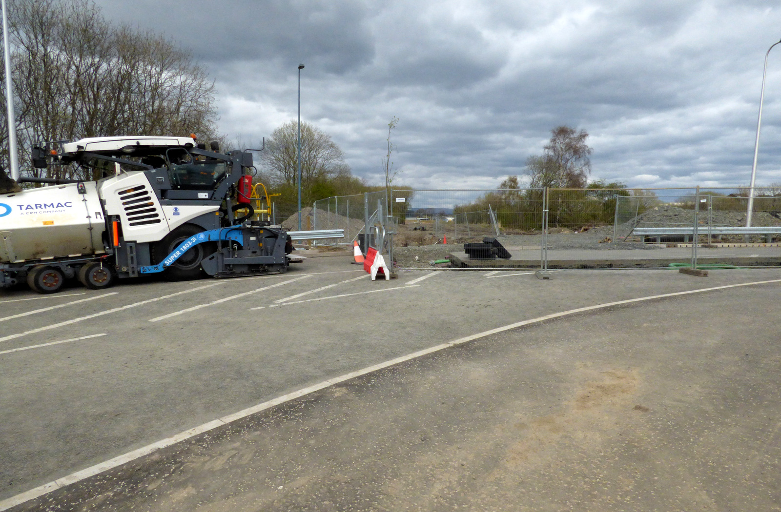 Asphalt paving machine laying fresh asphalt on a road surface in Renfrew, Scotland