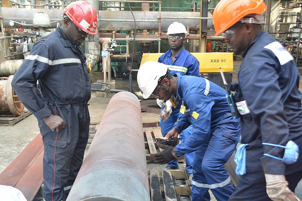 Workers performing maintenance on refinery equipment during a scheduled turnaround shutdown